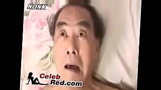 asian girl in red dress giving blowjob for guy sitting to his face riding on his cock on the couch i